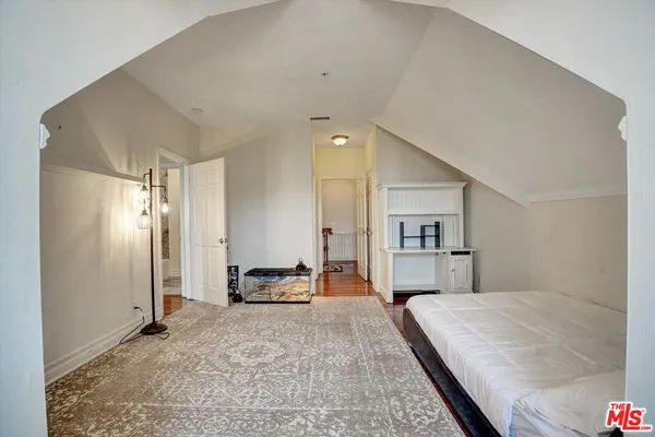 a bedroom with a large bed and furniture