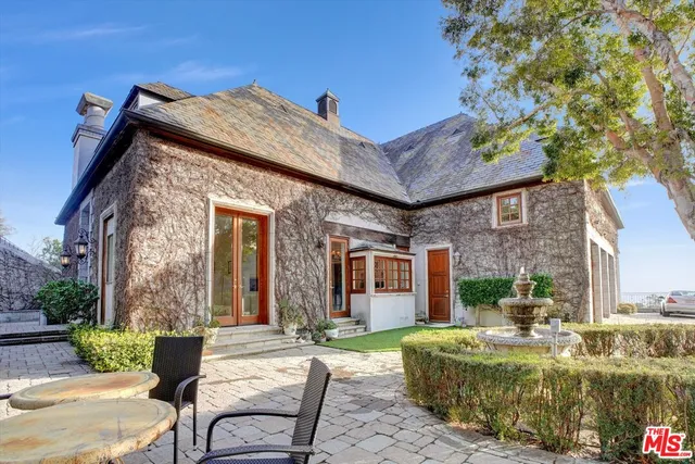 a view of house with yard outdoor seating and barbeque oven