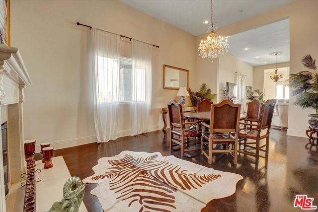 a living room with furniture a chandelier and a dining table