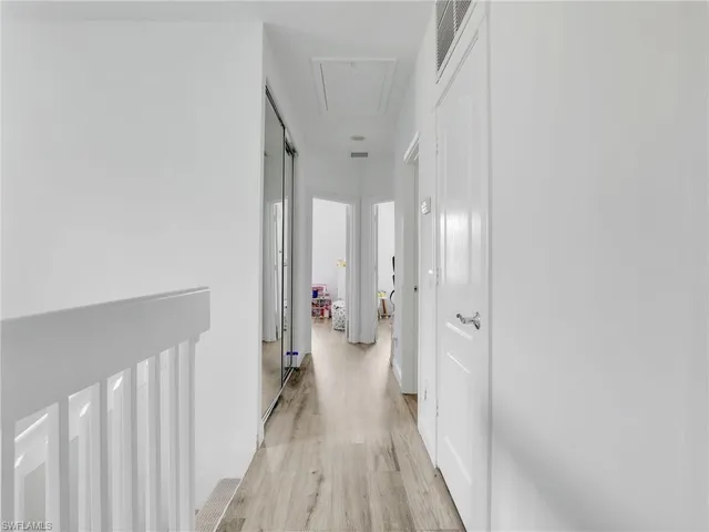 a view of a hallway with a white walls