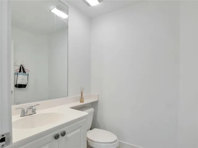 a bathroom with a sink toilet and vanity