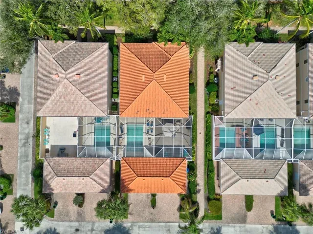 an aerial view of houses with a yard