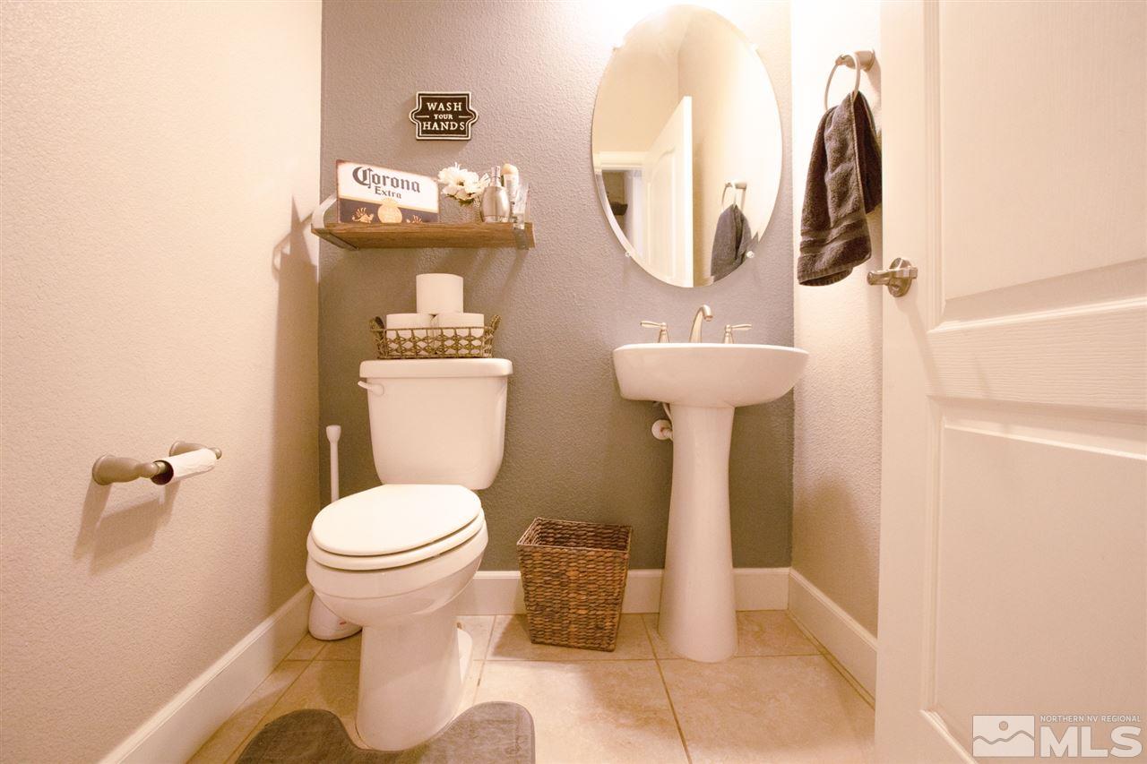 1885 Fledge Creek Drive Reno, NV 89521 - Photo 11 of 30 a bathroom with a toilet sink and mirror