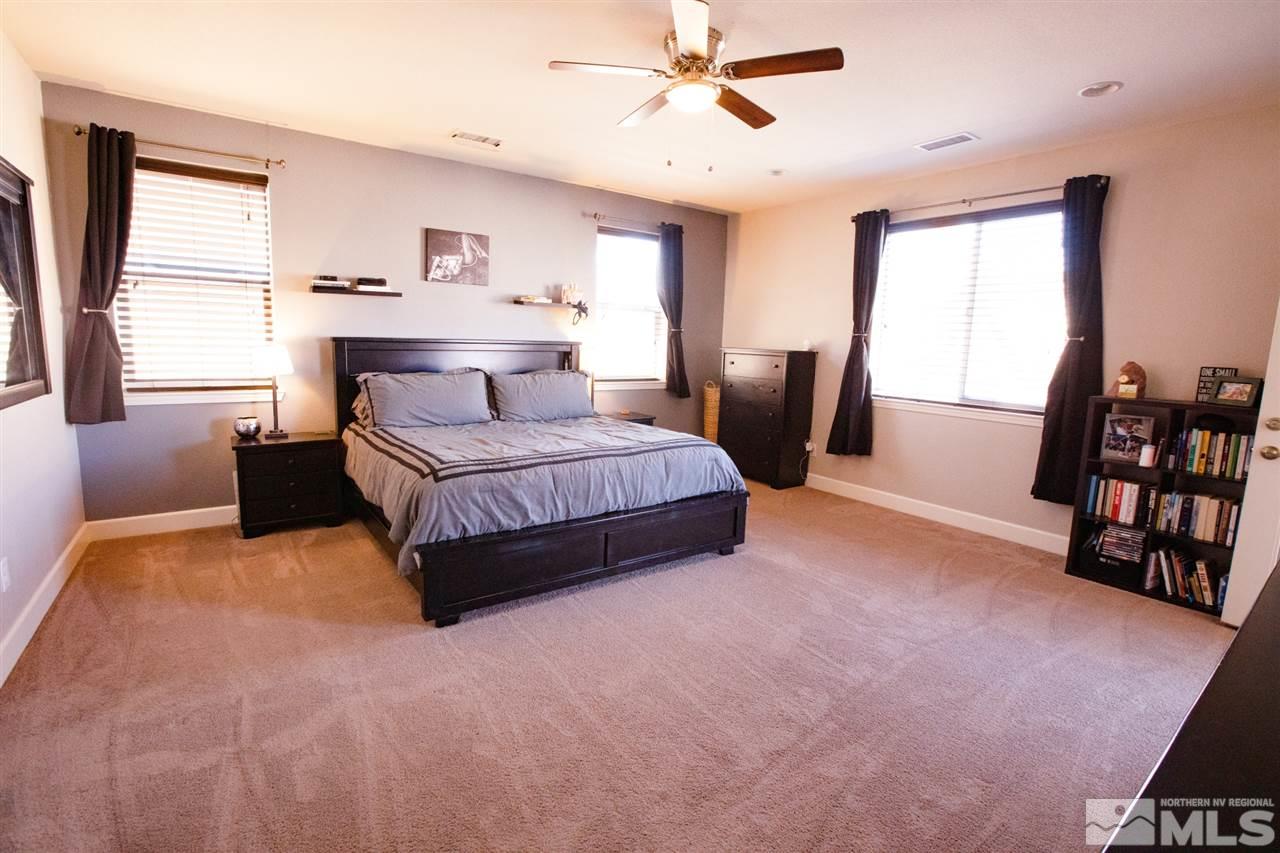 1885 Fledge Creek Drive Reno, NV 89521 - Photo 13 of 30 a living room with a bed furniture flat screen tv and a large window