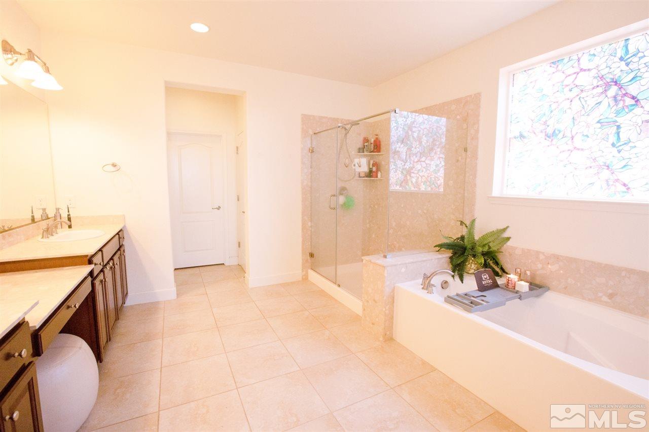 1885 Fledge Creek Drive Reno, NV 89521 - Photo 14 of 30 a spacious bathroom with a tub sink and mirror