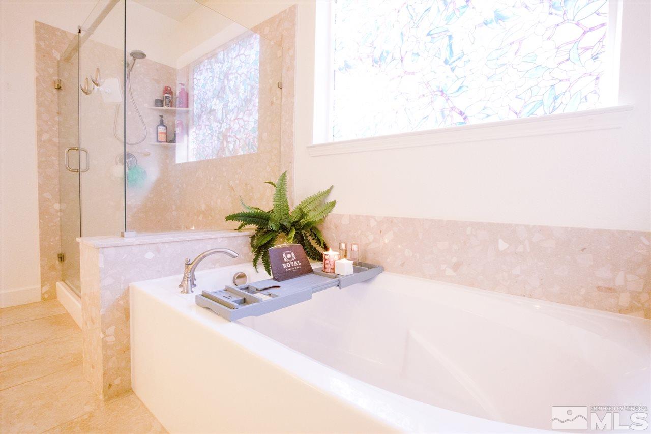 1885 Fledge Creek Drive Reno, NV 89521 - Photo 15 of 30 a bathroom with a granite countertop sink a mirror and a shower