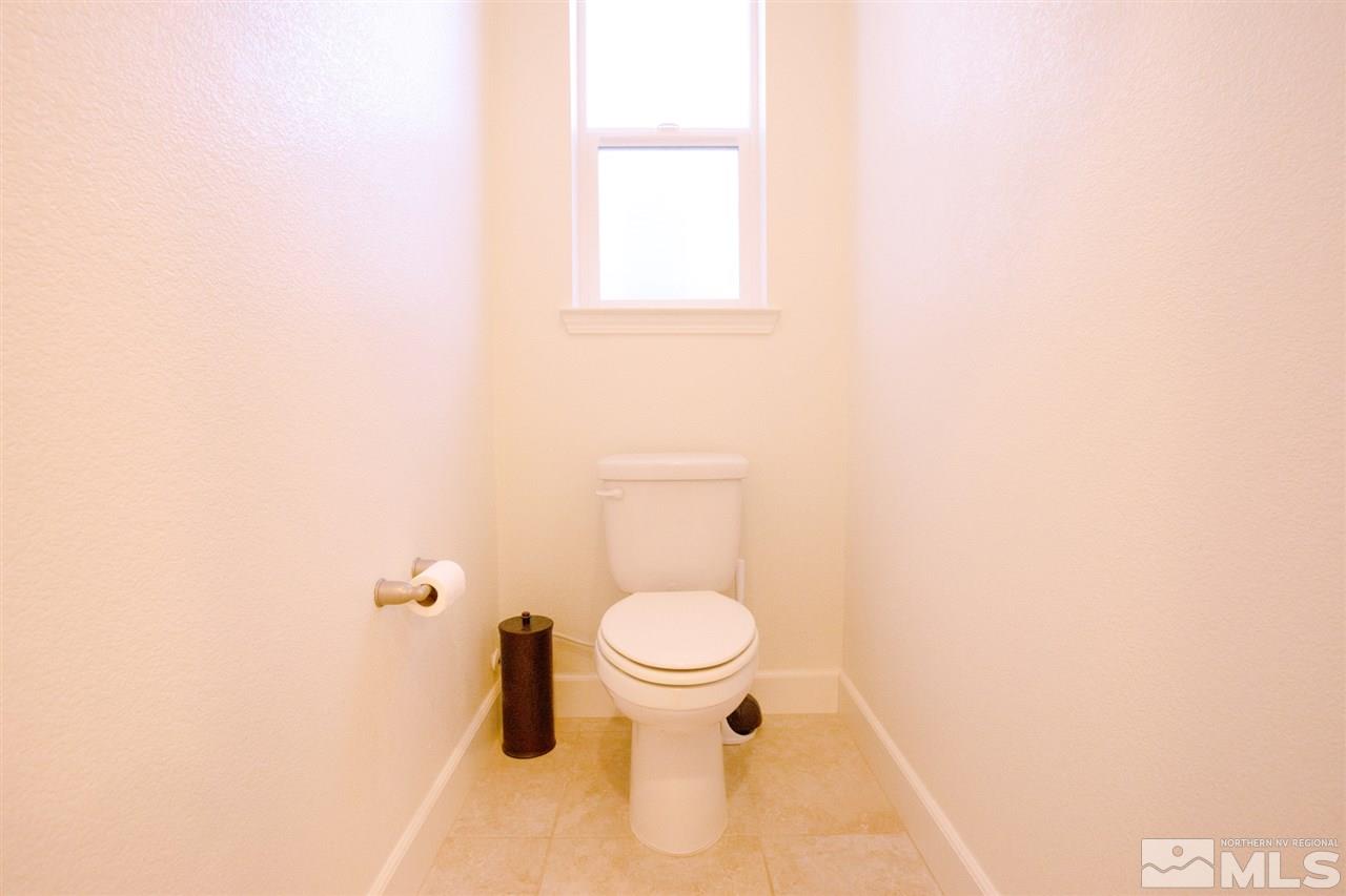 1885 Fledge Creek Drive Reno, NV 89521 - Photo 17 of 30 a bathroom with a toilet and a window