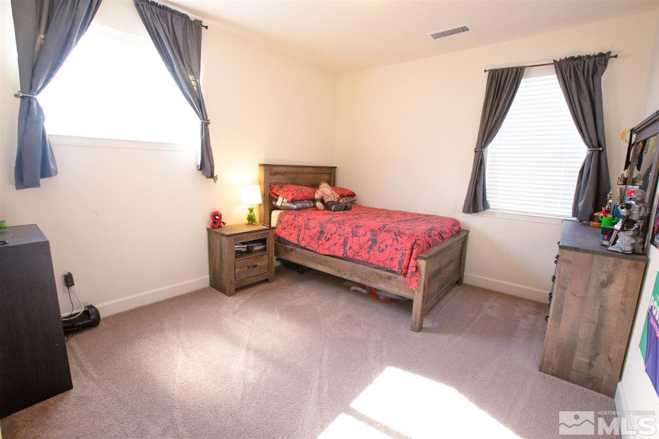 1885 Fledge Creek Drive Reno, NV 89521 - Photo 19 of 30 a bedroom with a bed and a window
