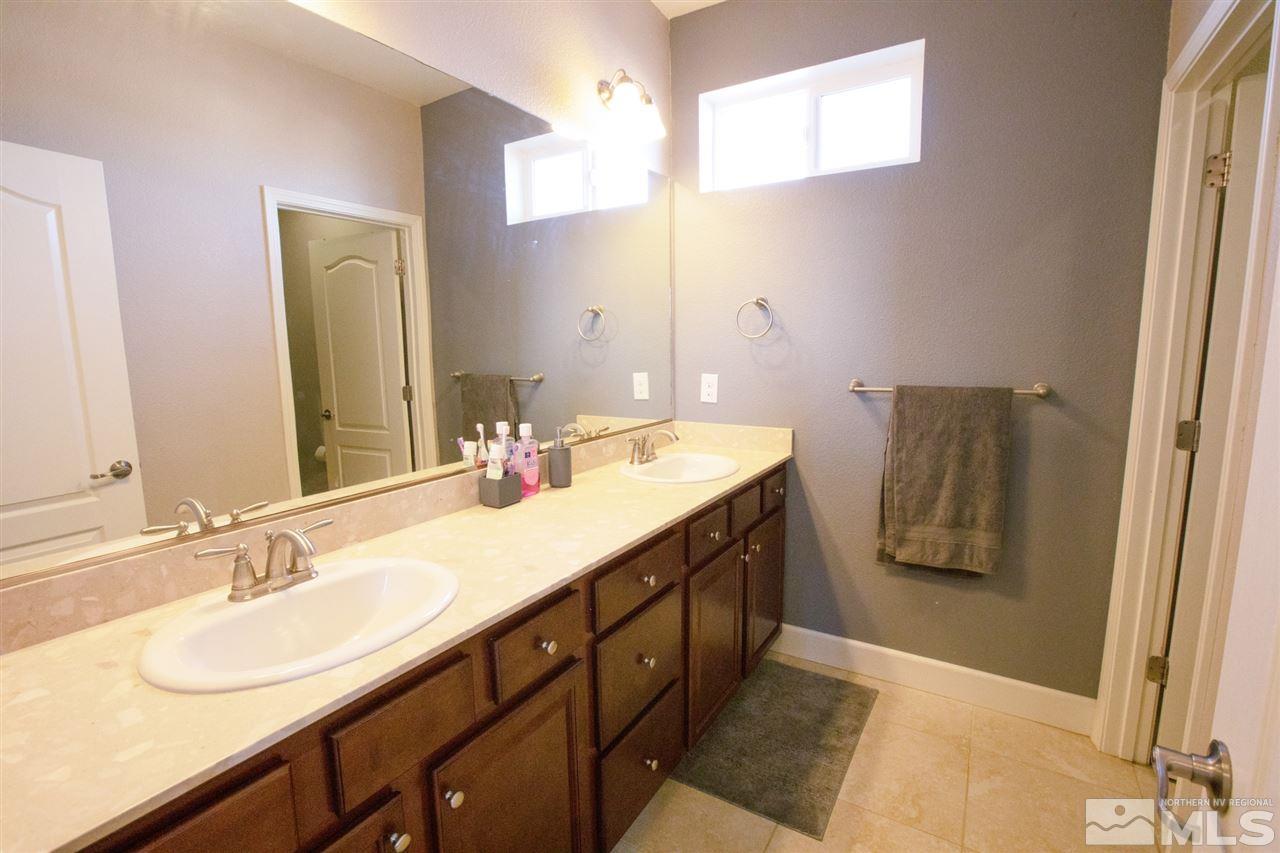 1885 Fledge Creek Drive Reno, NV 89521 - Photo 20 of 30 a bathroom with a sink double vanity and a mirror