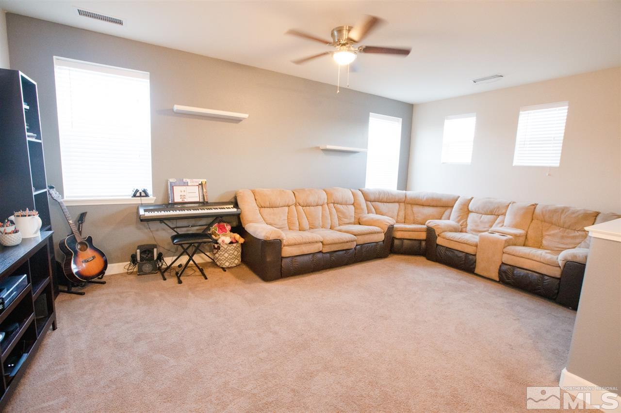 1885 Fledge Creek Drive Reno, NV 89521 - Photo 21 of 30 a living room with furniture and a chandelier