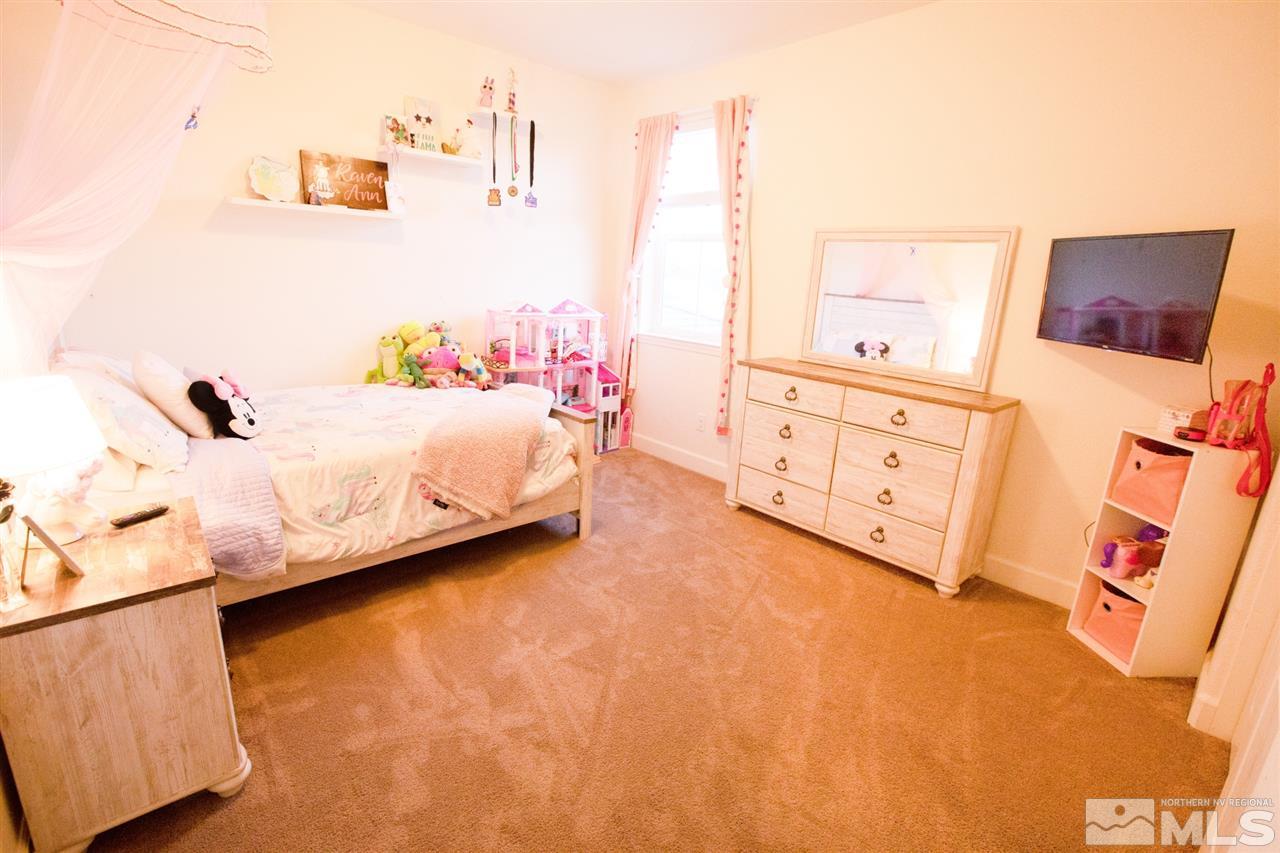 1885 Fledge Creek Drive Reno, NV 89521 - Photo 23 of 30 a bedroom with furniture and a window