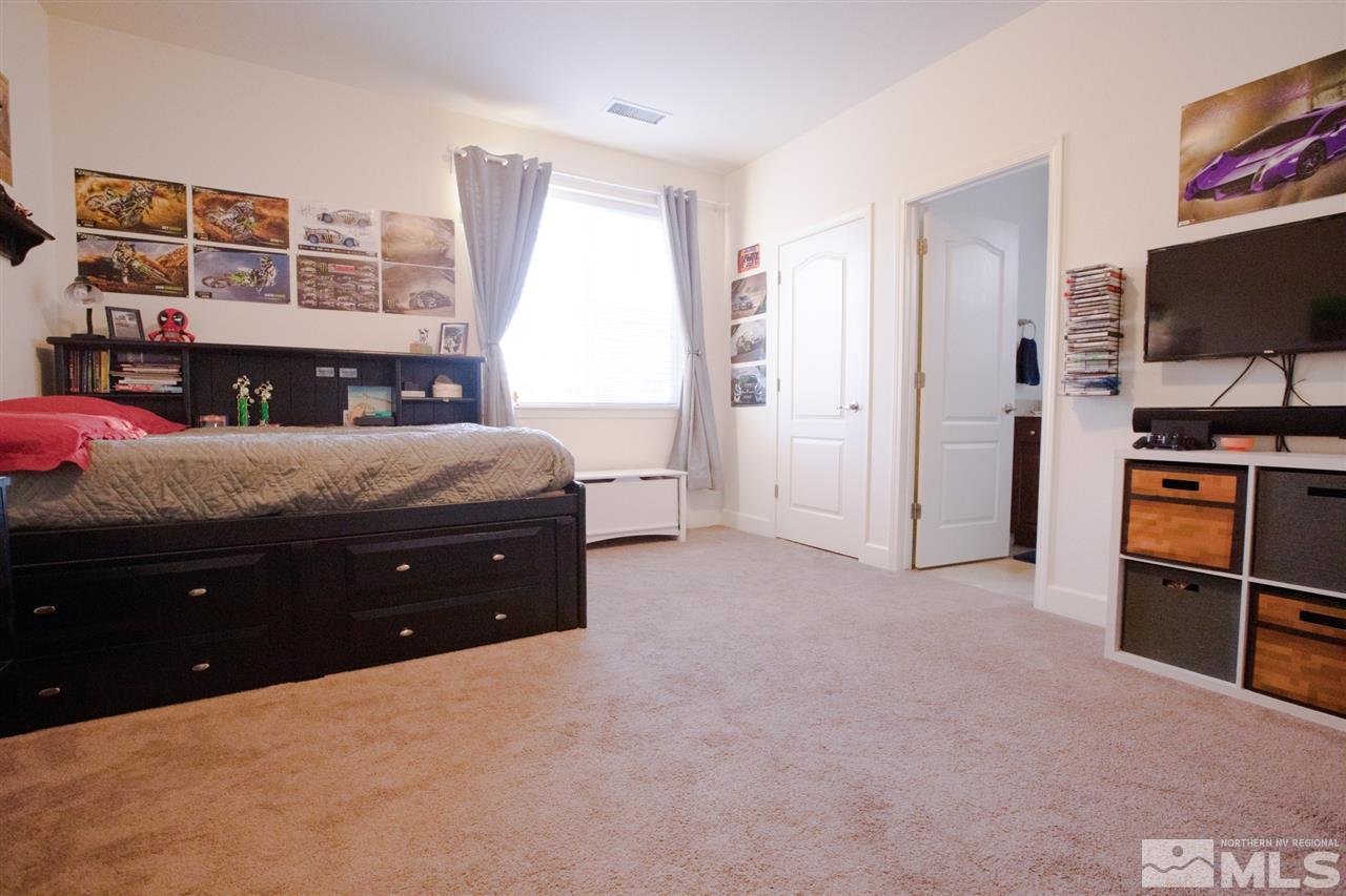 1885 Fledge Creek Drive Reno, NV 89521 - Photo 25 of 30 a room with a bed and a television