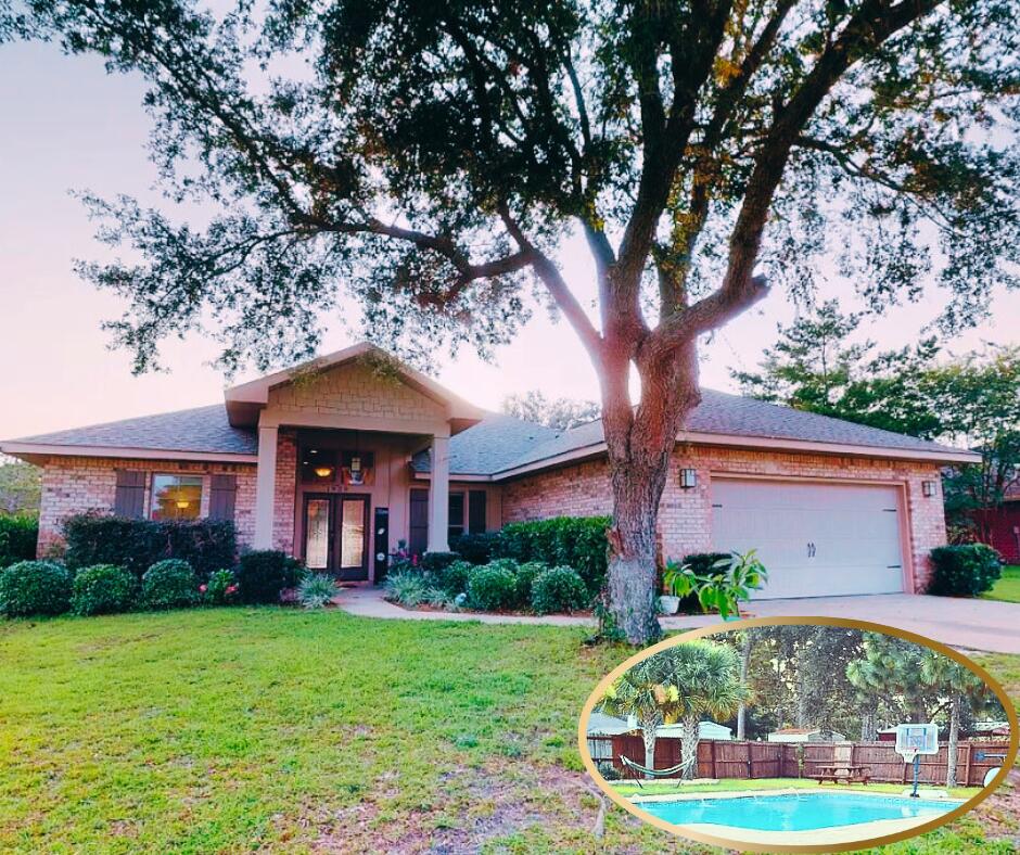 1959 Commodore Drive Navarre, FL 32566 - Photo 1 of 56 a front view of a house with garden