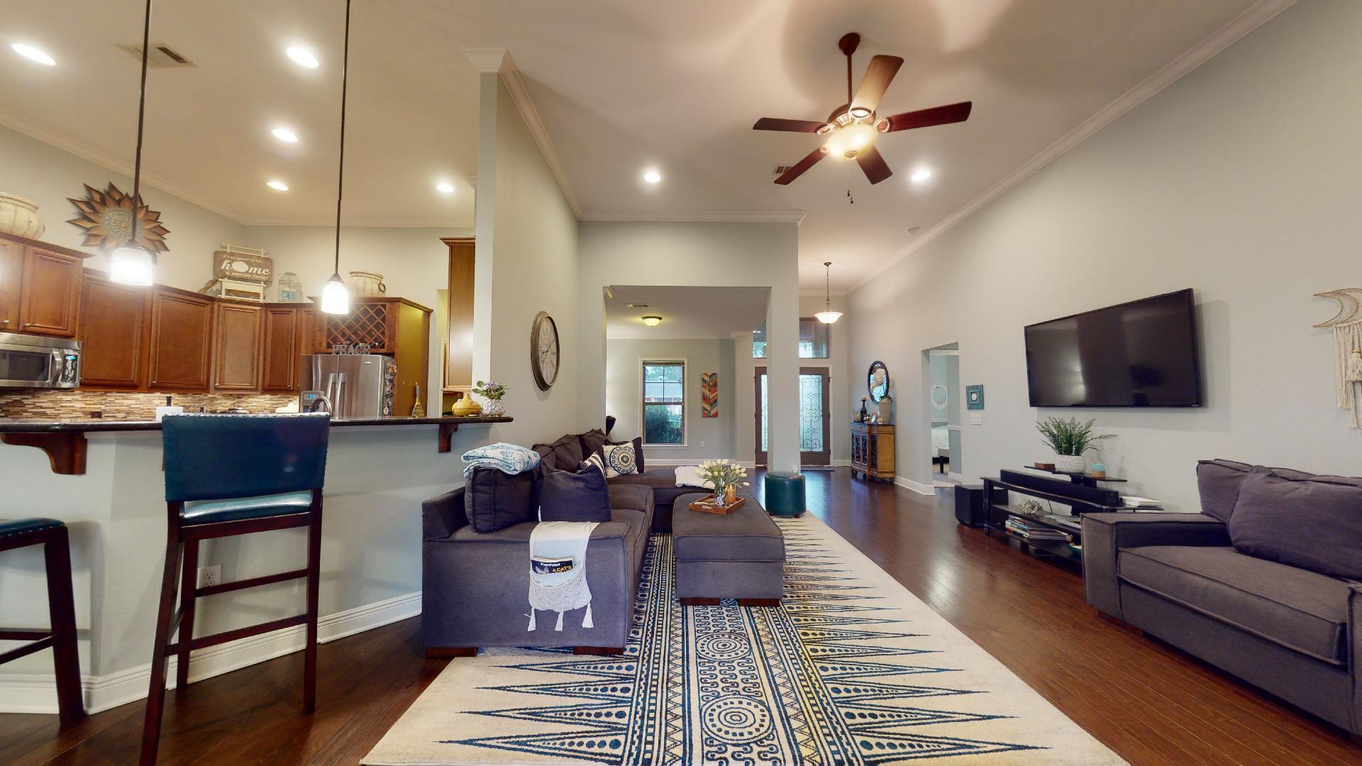 1959 Commodore Drive Navarre, FL 32566 - Photo 15 of 56 a living room with furniture kitchen view and a chandelier