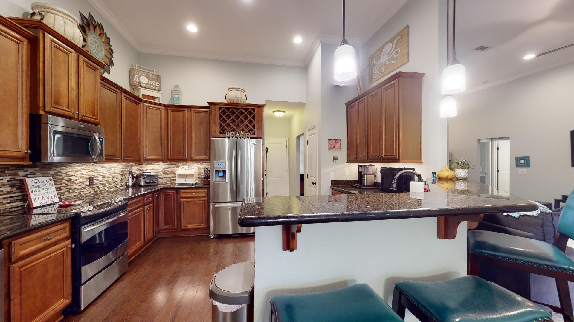 1959 Commodore Drive Navarre, FL 32566 - Photo 18 of 56 a kitchen with stainless steel appliances granite countertop a sink stove and refrigerator