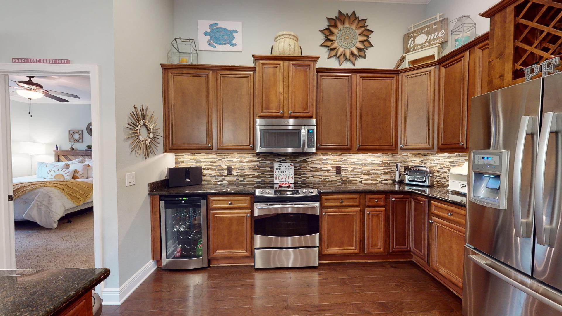 1959 Commodore Drive Navarre, FL 32566 - Photo 20 of 56 a kitchen with stainless steel appliances granite countertop a stove a sink dishwasher and a microwave oven with cabinets