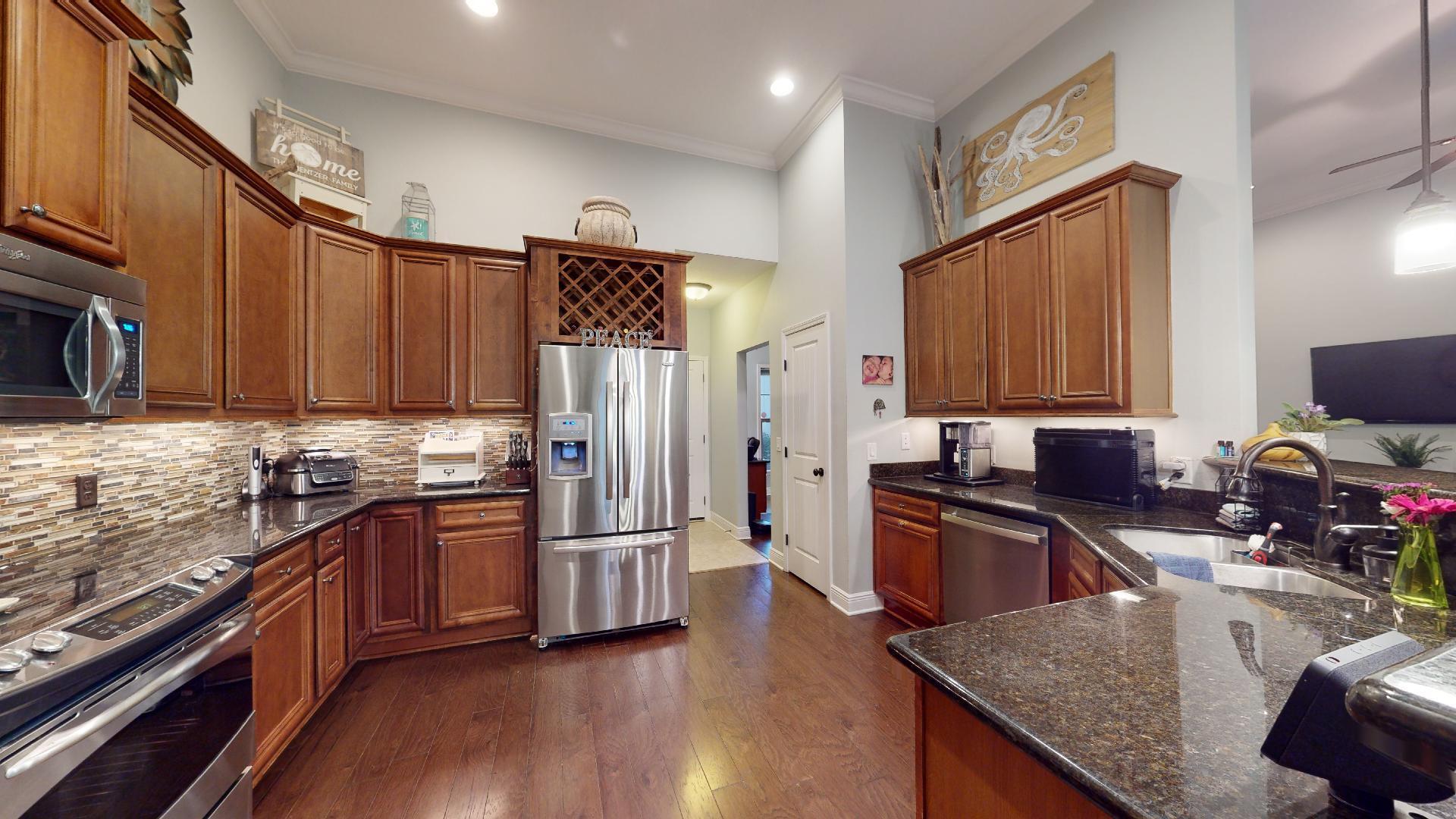 1959 Commodore Drive Navarre, FL 32566 - Photo 21 of 56 a kitchen with granite countertop stainless steel appliances and wooden cabinets
