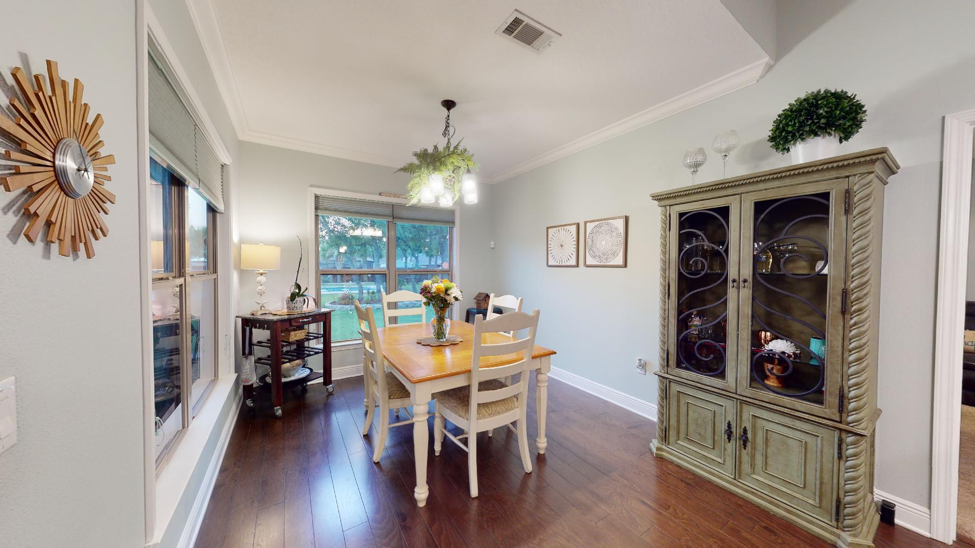 1959 Commodore Drive Navarre, FL 32566 - Photo 22 of 56 a view of a dining room with furniture and wooden floor