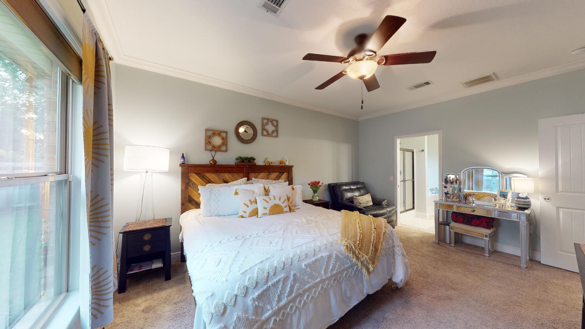 1959 Commodore Drive Navarre, FL 32566 - Photo 26 of 56 a bedroom with bed and a chandelier