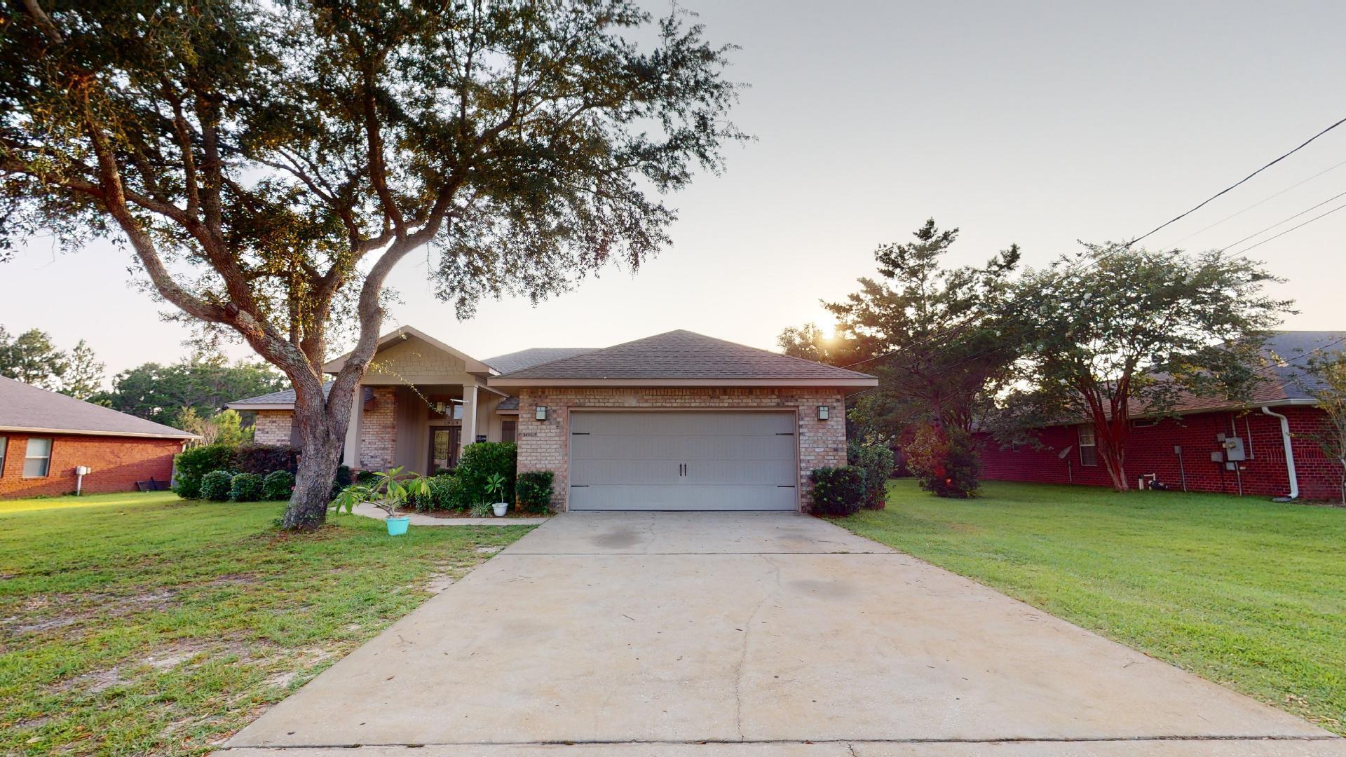 1959 Commodore Drive Navarre, FL 32566 - Photo 3 of 56 a front view of house with yard and green space