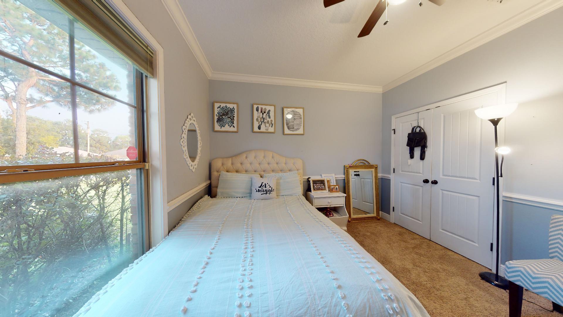 1959 Commodore Drive Navarre, FL 32566 - Photo 33 of 56 a bed room with a bed and a large window