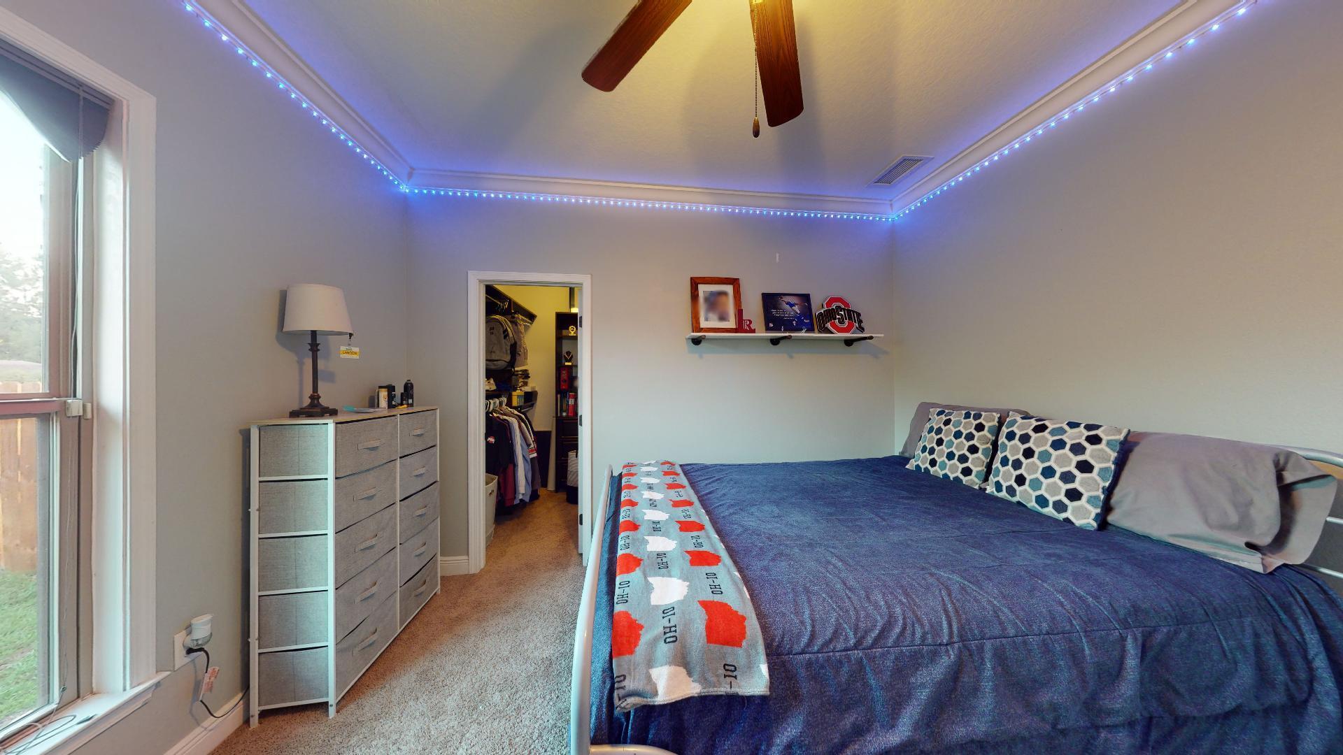 1959 Commodore Drive Navarre, FL 32566 - Photo 36 of 56 a bedroom with a bed and a book shelf