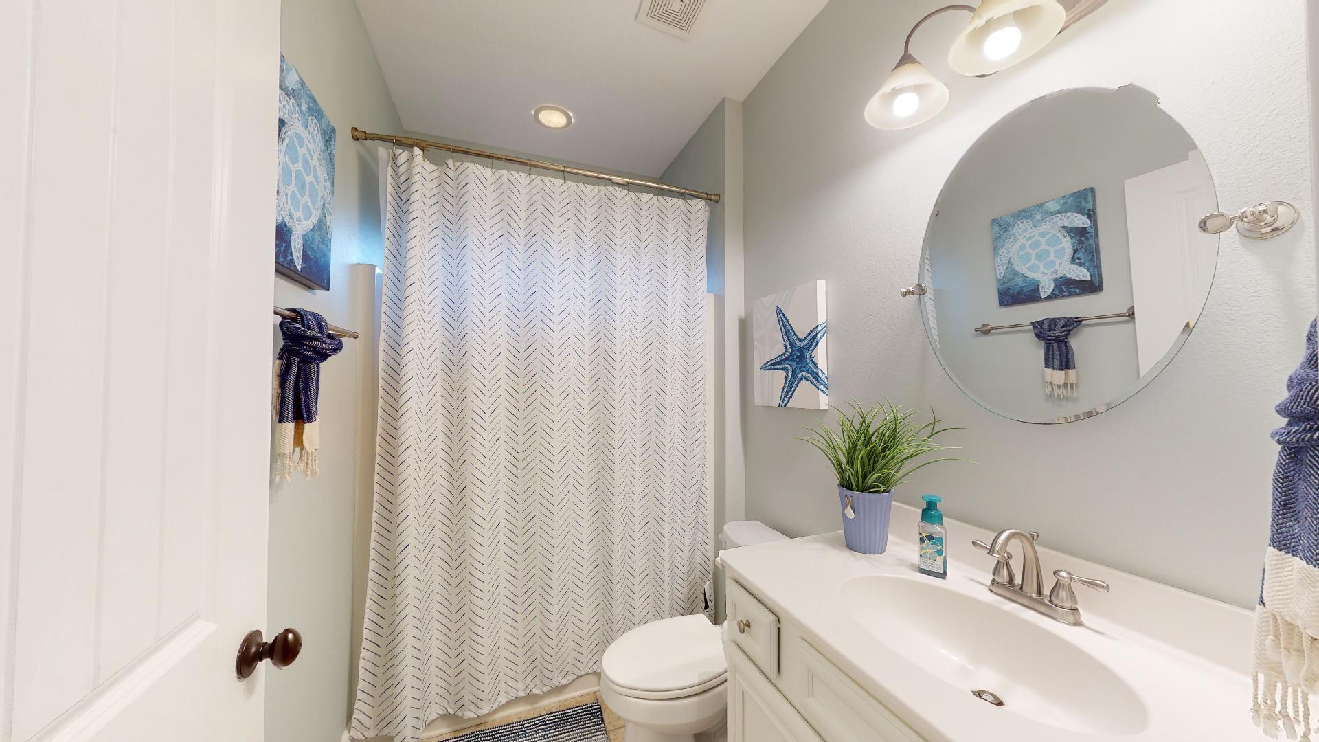 1959 Commodore Drive Navarre, FL 32566 - Photo 37 of 56 a bathroom with a toilet a sink and a mirror