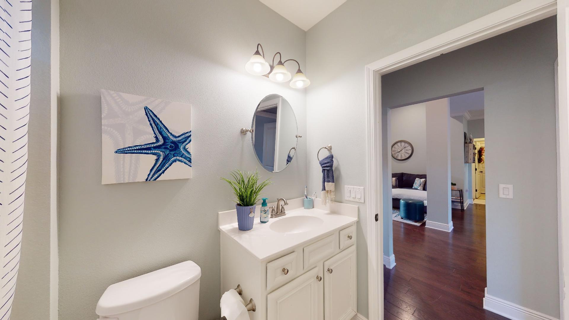 1959 Commodore Drive Navarre, FL 32566 - Photo 38 of 56 a bathroom with a sink vanity and a mirror