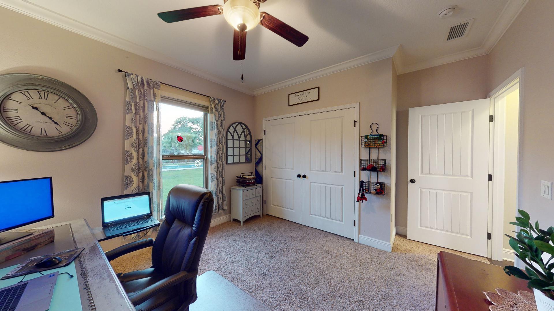 1959 Commodore Drive Navarre, FL 32566 - Photo 40 of 56 a view of a workspace with furniture and a window