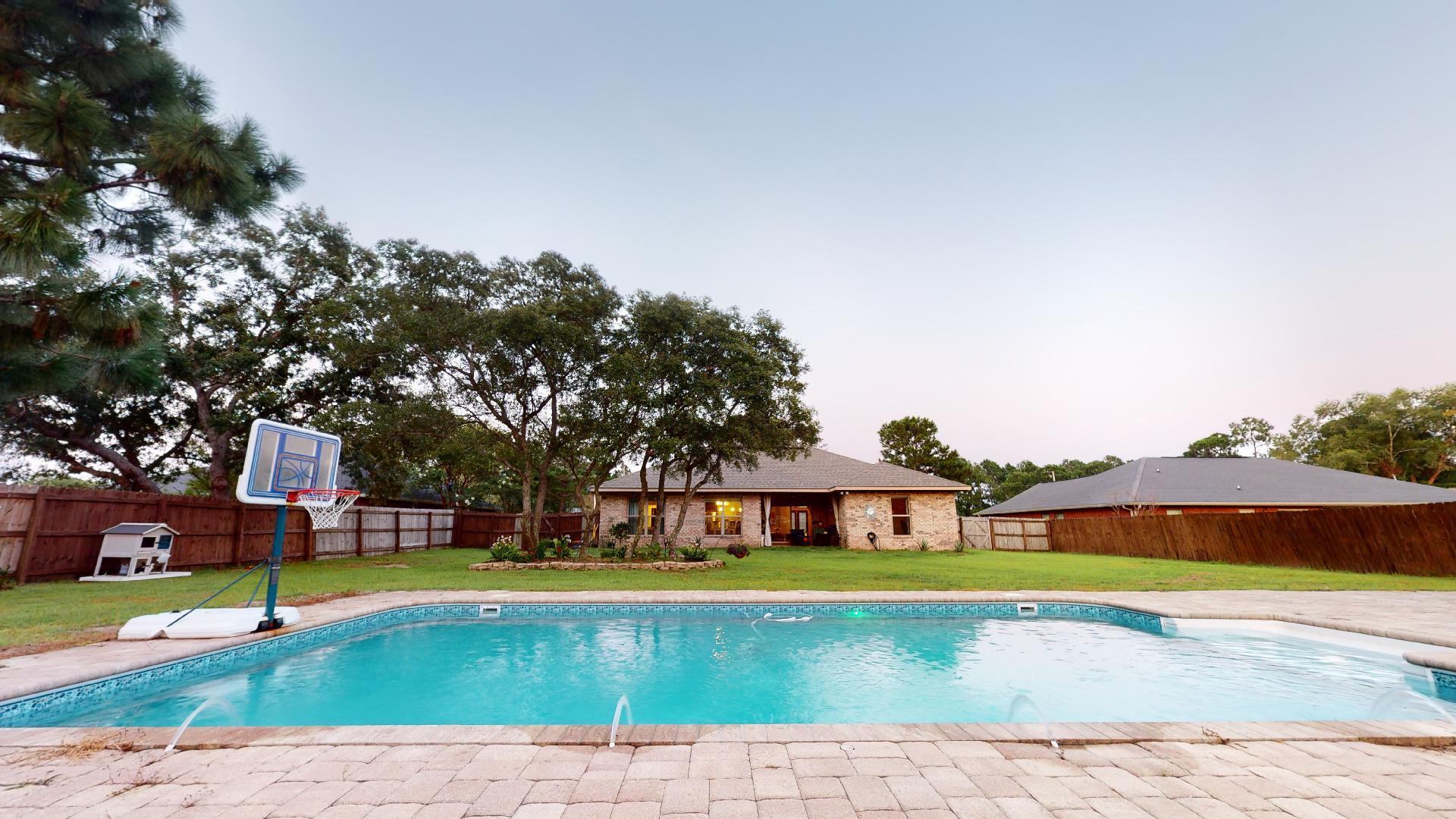 1959 Commodore Drive Navarre, FL 32566 - Photo 46 of 56 a front view of a house with a swimming pool