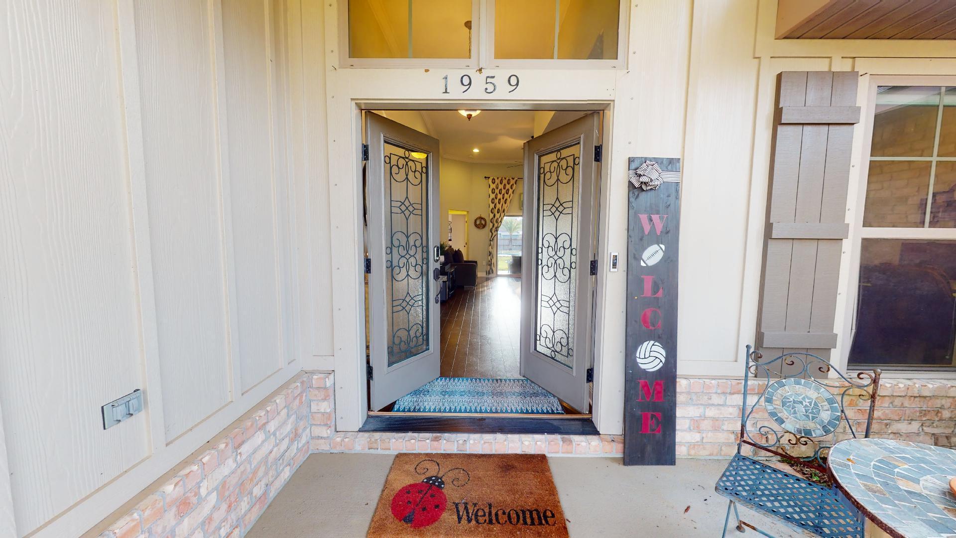 1959 Commodore Drive Navarre, FL 32566 - Photo 7 of 56 a view of a hallway with wooden floor and a bathroom