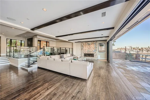 a living room with furniture and a floor to ceiling window