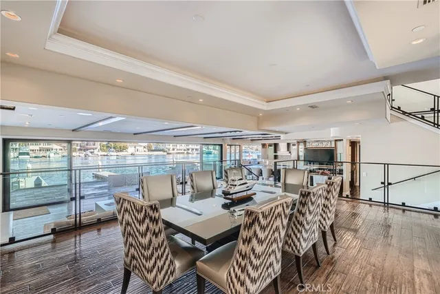 a view of a kitchen with kitchen island stainless steel appliances a sink and counter top space