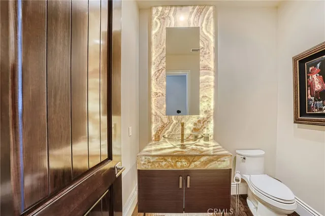 a spacious bedroom with a balcony a bed and a chandelier