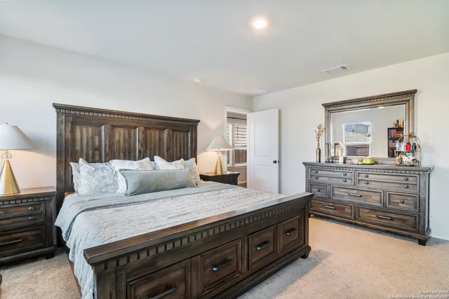 a bedroom with a large bed and a dresser
