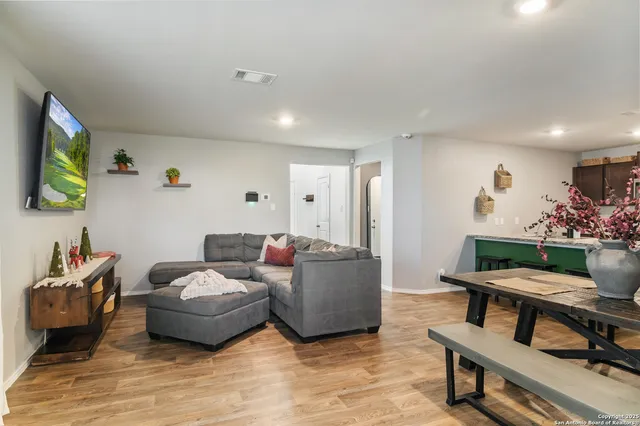a living room with furniture and flowers