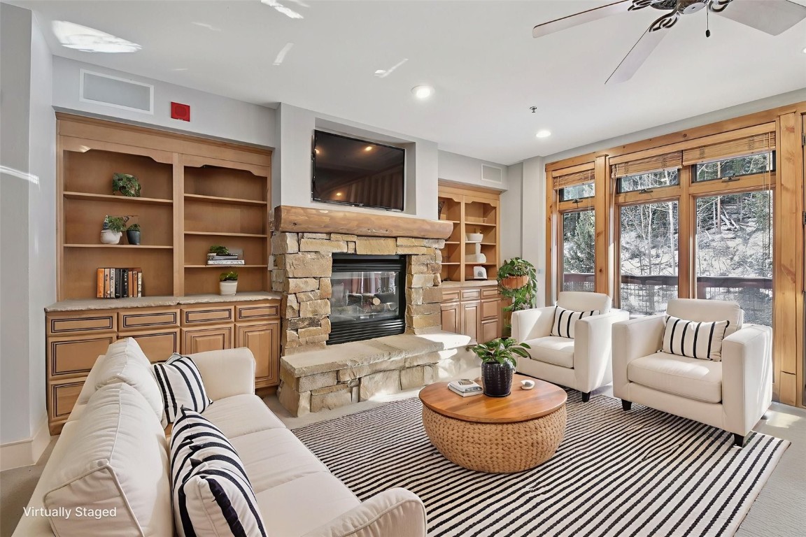 a living room with fireplace furniture and a flat screen tv