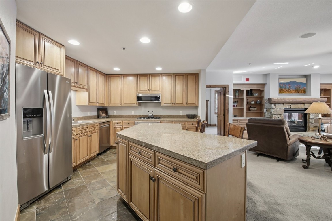 224 Trailhead Drive, Unit 3074 Keystone, CO 80435 - Photo 15 of 49 a kitchen with a refrigerator a oven a sink a dining table and chairs