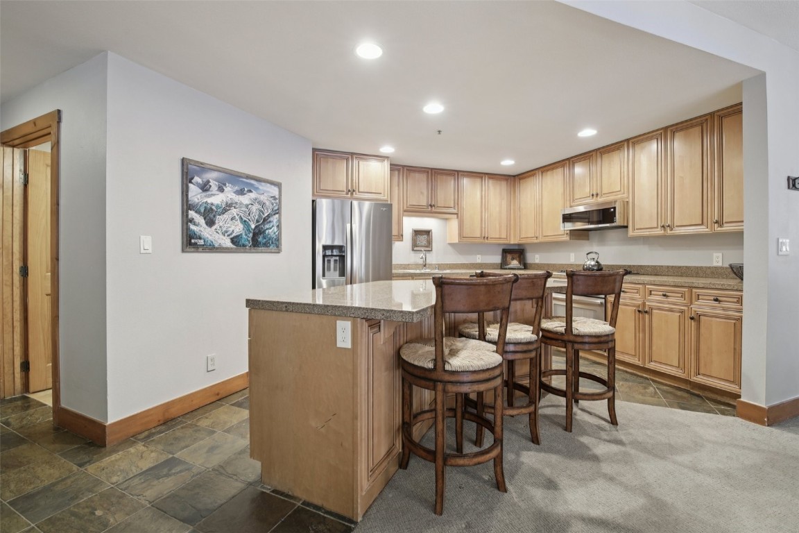 224 Trailhead Drive, Unit 3074 Keystone, CO 80435 - Photo 16 of 49 a kitchen with granite countertop cabinets and refrigerator