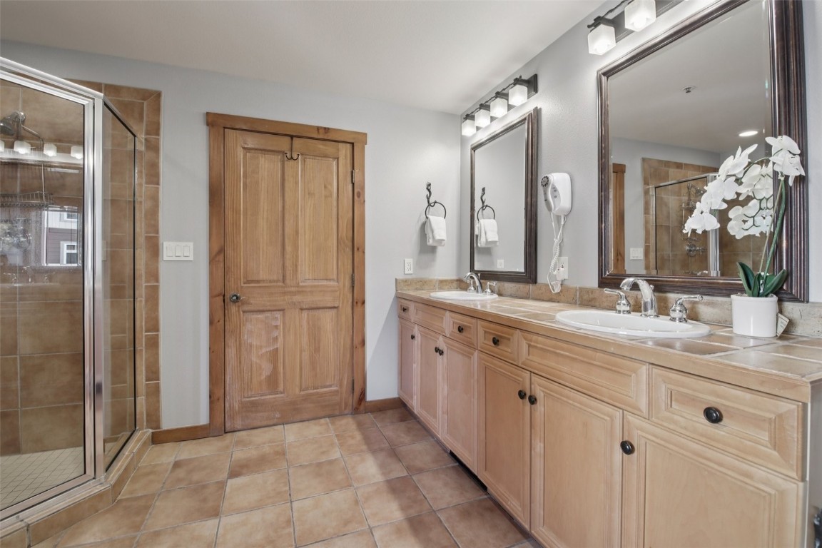 224 Trailhead Drive, Unit 3074 Keystone, CO 80435 - Photo 30 of 49 a spacious bathroom with a granite countertop sink a mirror and a shower