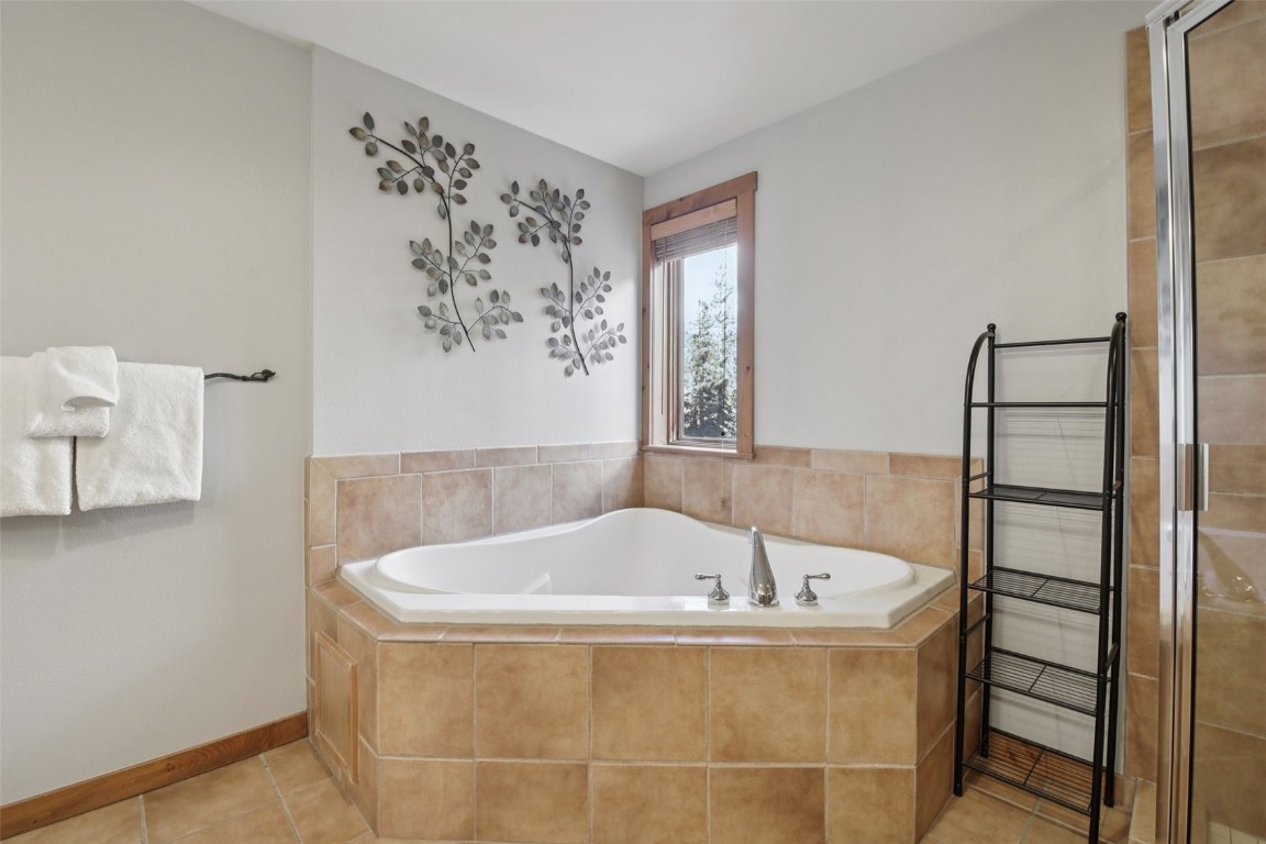 224 Trailhead Drive, Unit 3074 Keystone, CO 80435 - Photo 31 of 49 a bathroom with a bathtub and window