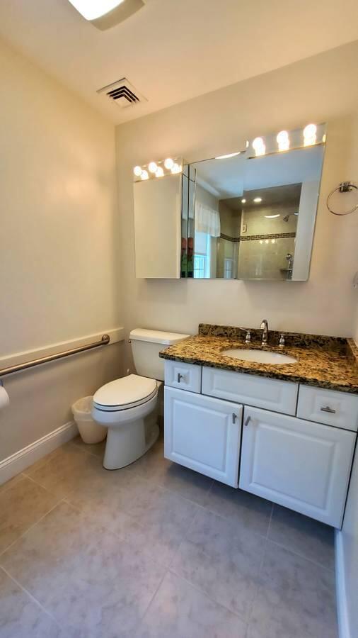 3 Kalmia Path Sandwich, MA 02563 - Photo 11 of 22 a bathroom with a granite countertop sink a toilet and a mirror