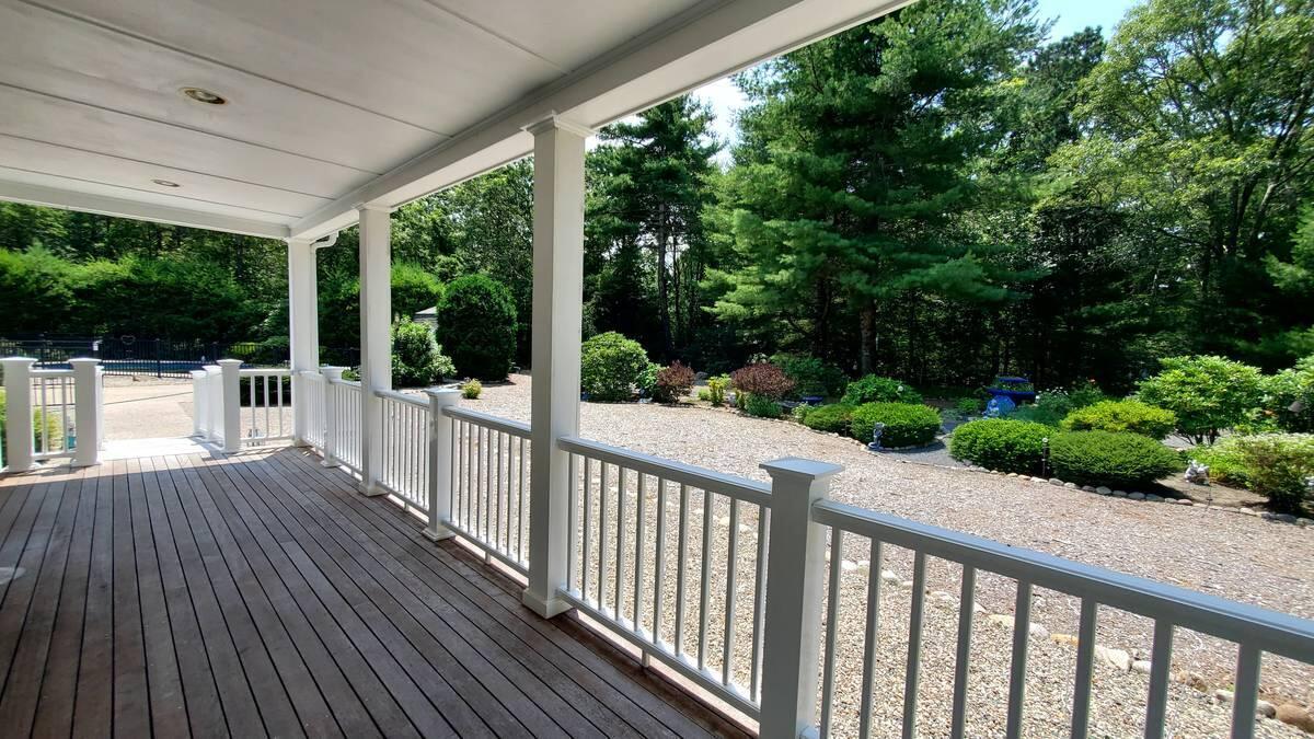 3 Kalmia Path Sandwich, MA 02563 - Photo 19 of 22 a view of a porch with wooden floor and yard next to a yard