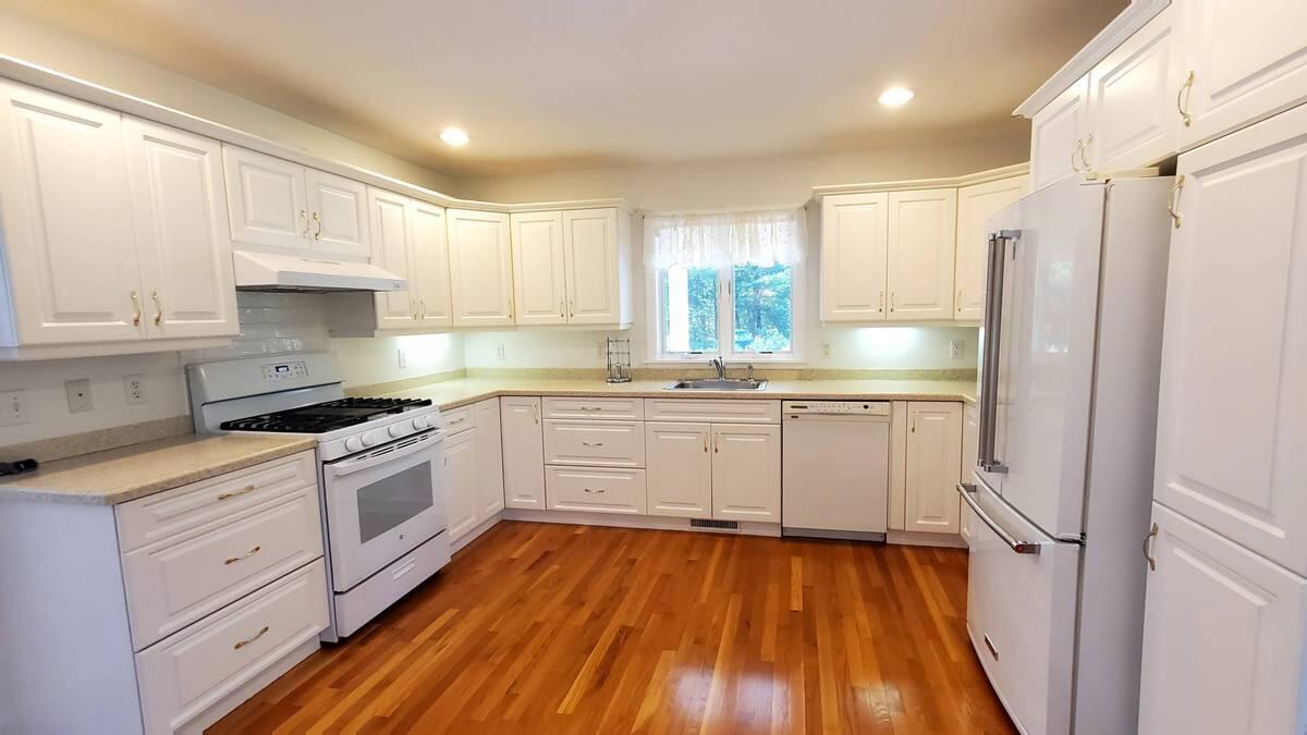 3 Kalmia Path Sandwich, MA 02563 - Photo 3 of 22 a kitchen with white cabinets and white appliances
