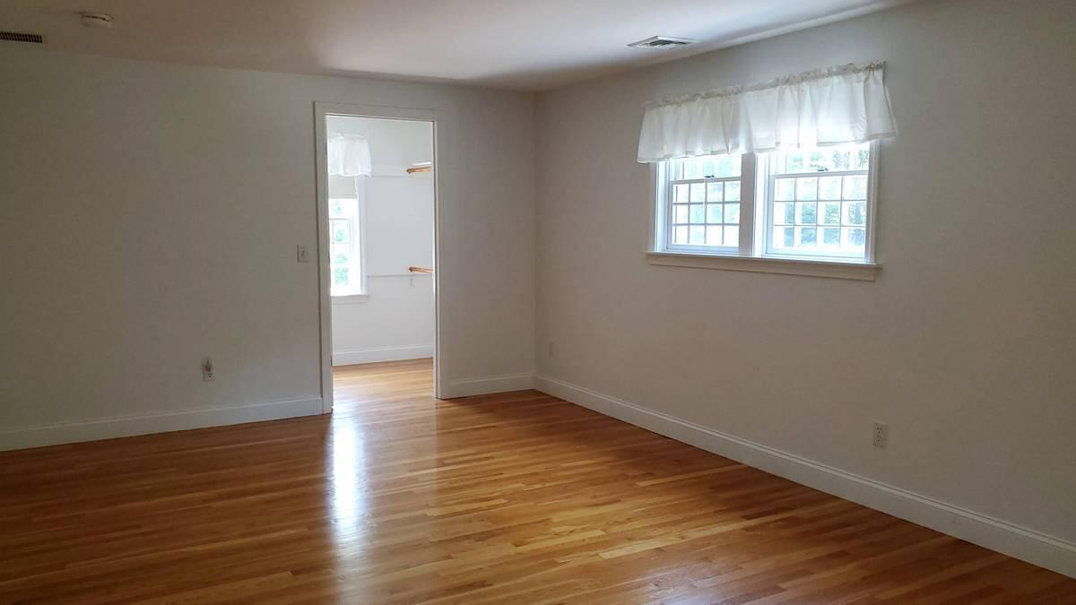 3 Kalmia Path Sandwich, MA 02563 - Photo 8 of 22 an empty room with wooden floor and windows