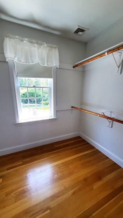 3 Kalmia Path Sandwich, MA 02563 - Photo 9 of 22 a view of an empty room with a window and wooden floor