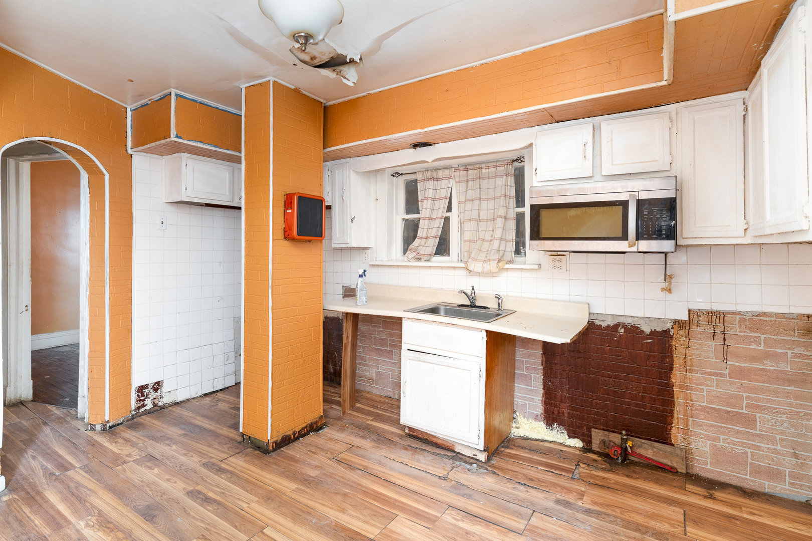 5239 South Ingleside Avenue Chicago, IL 60615 - Photo 7 of 25 a kitchen with stainless steel appliances granite countertop a refrigerator a stove top oven a sink and dishwasher with wooden floor