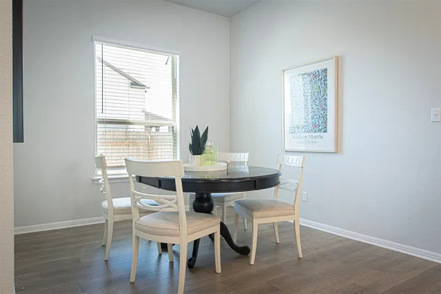 a view of a dining room with furniture and wooden floor