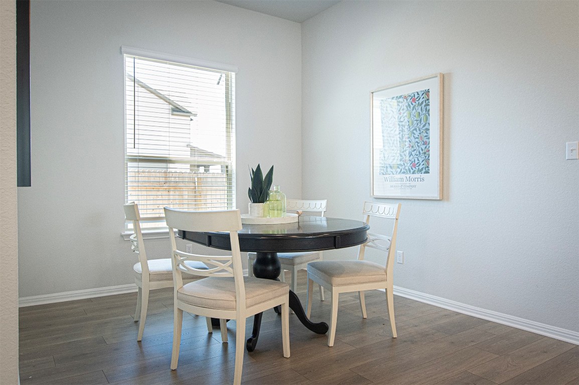249 Treadwell Lane Kyle, TX 78640 - Photo 11 of 32 a view of a dining room with furniture and wooden floor