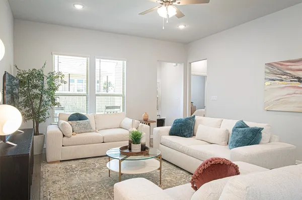 a living room with furniture and a large window